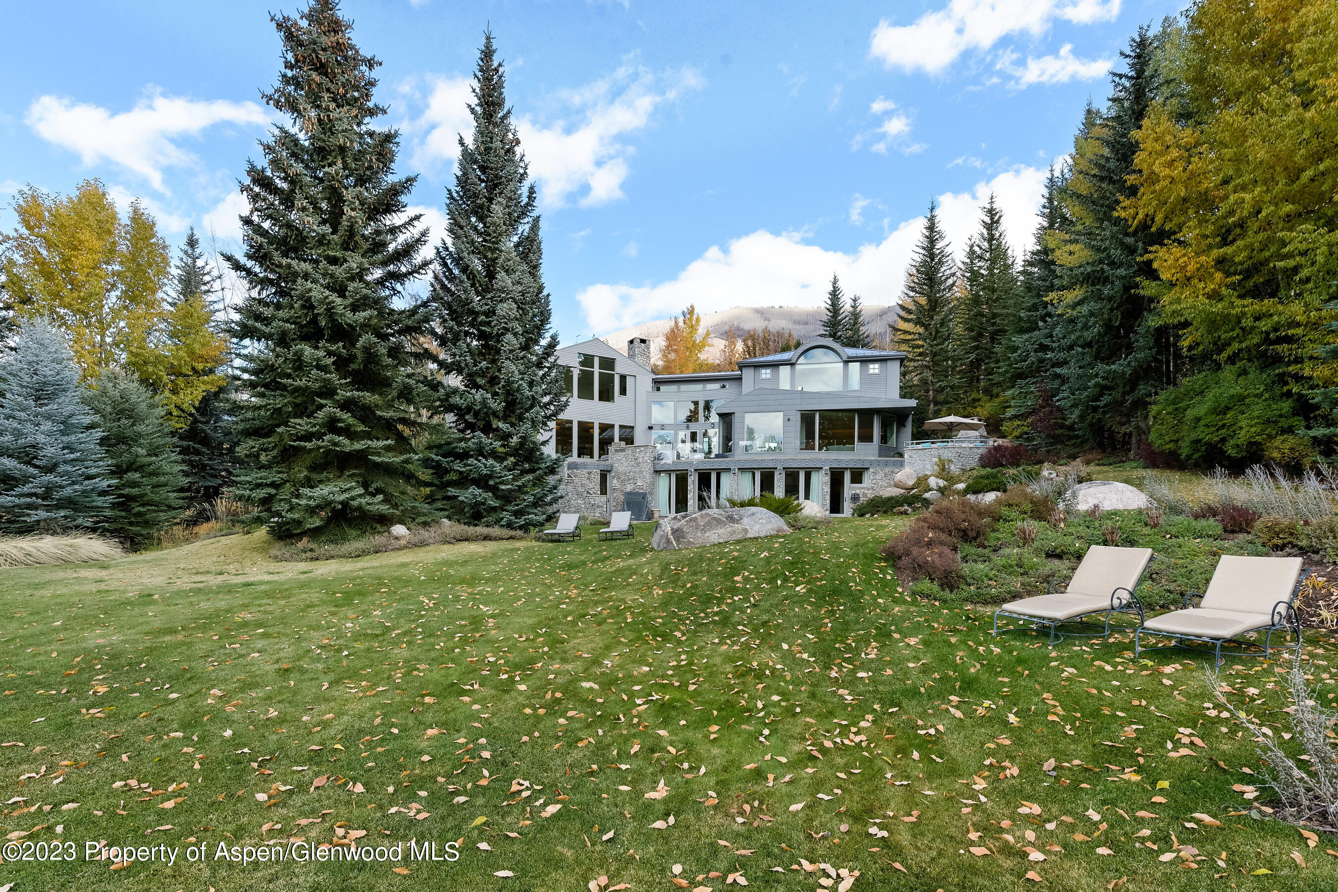 58 Pitkin Way Aspen, CO 81611 - Photo 27 of 33 a view of a house with a backyard porch and sitting area