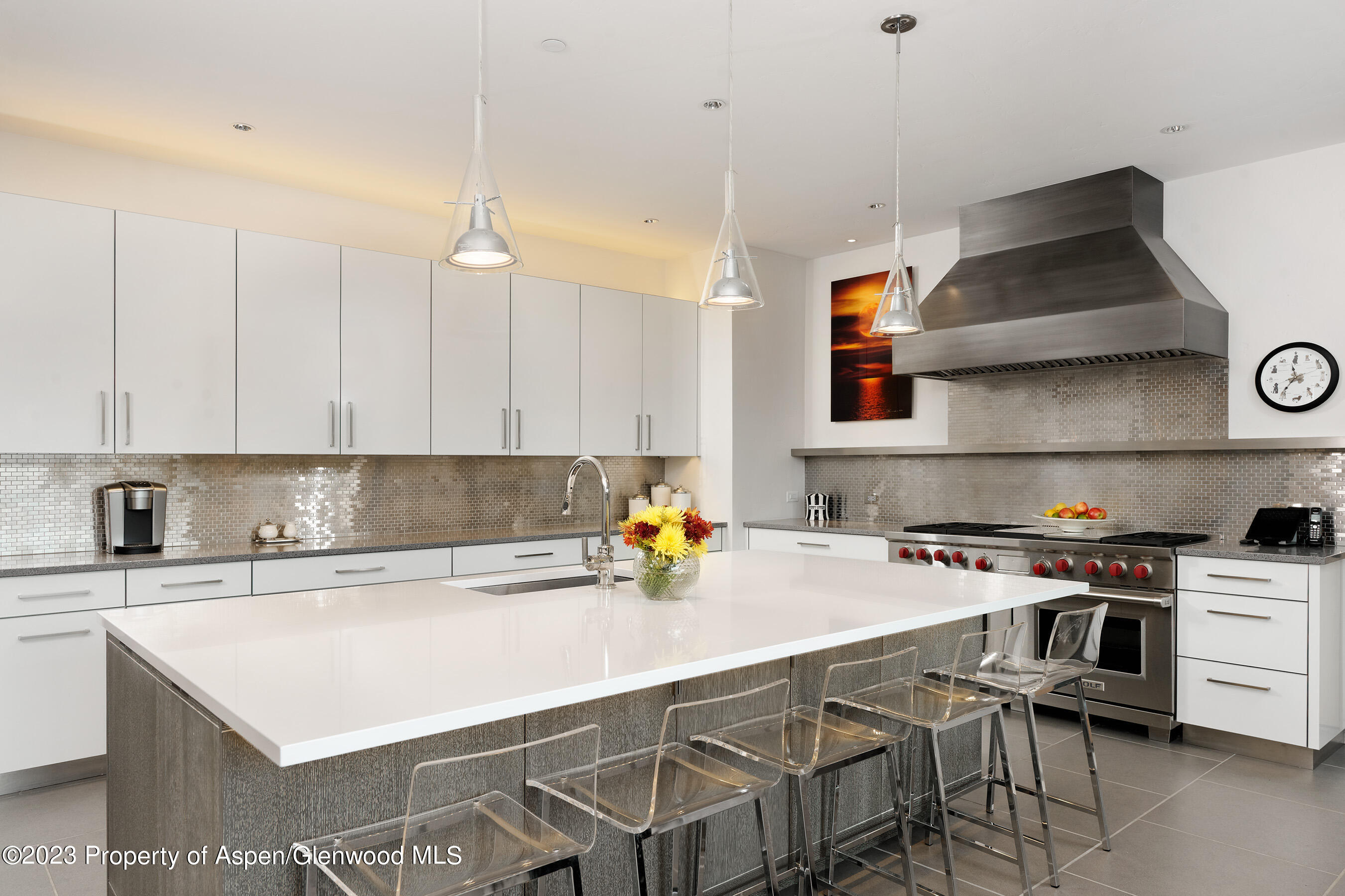 58 Pitkin Way Aspen, CO 81611 - Photo 5 of 33 a kitchen with a sink a stove and chairs