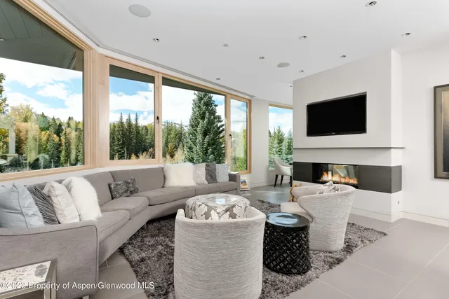 a living room with fireplace furniture and a flat screen tv