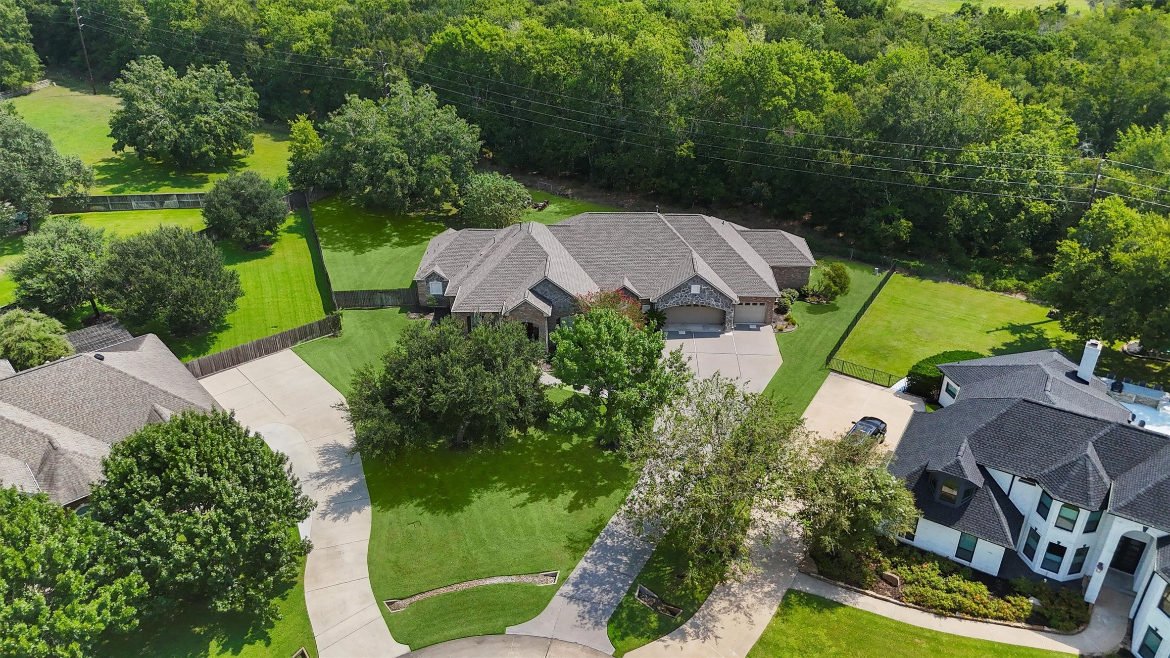 an aerial view of a house with garden space and street view