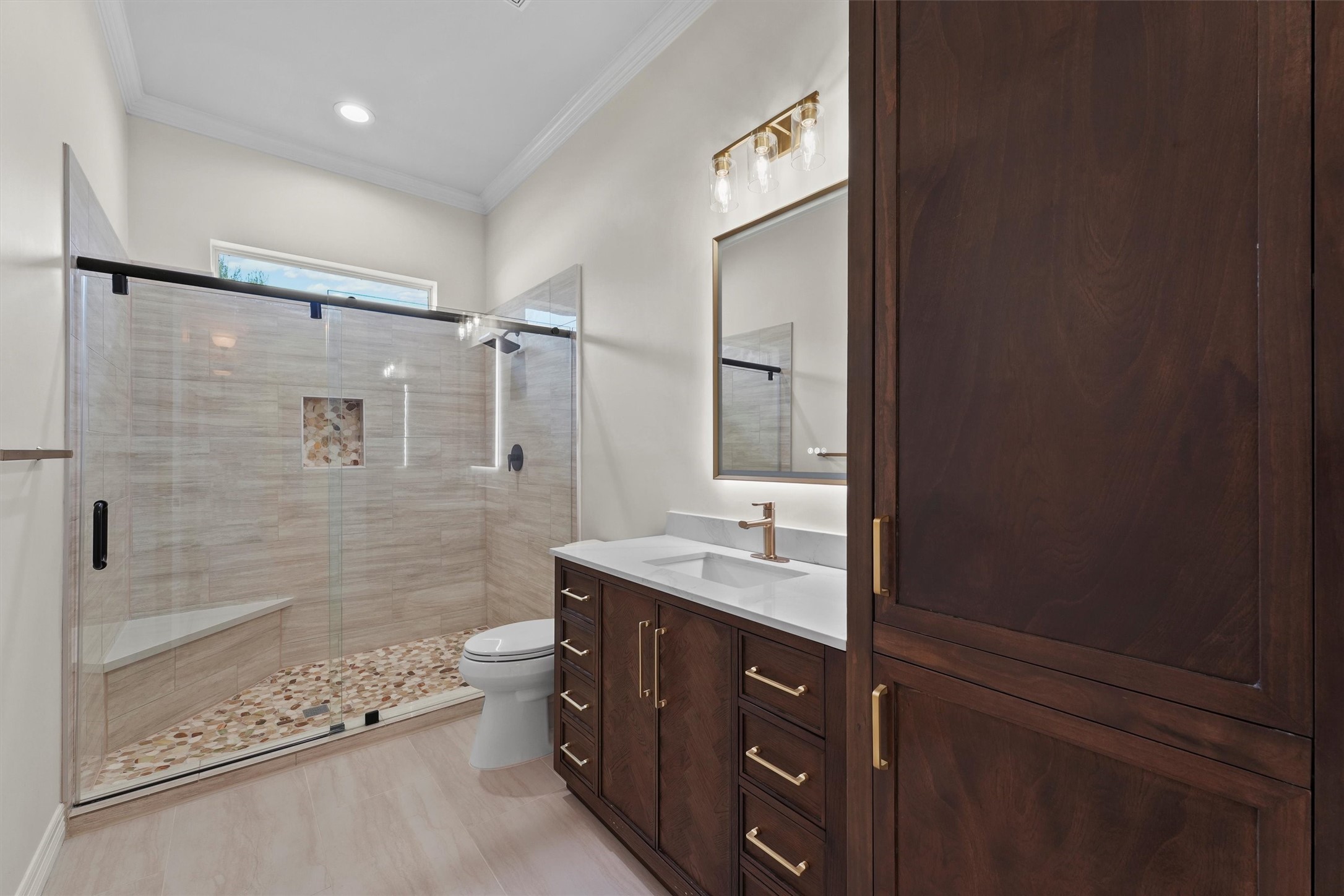 4102 Worthing Drive Fulshear, TX 77441 - Photo 17 of 30 a bathroom with a double vanity sink toilet mirror and shower