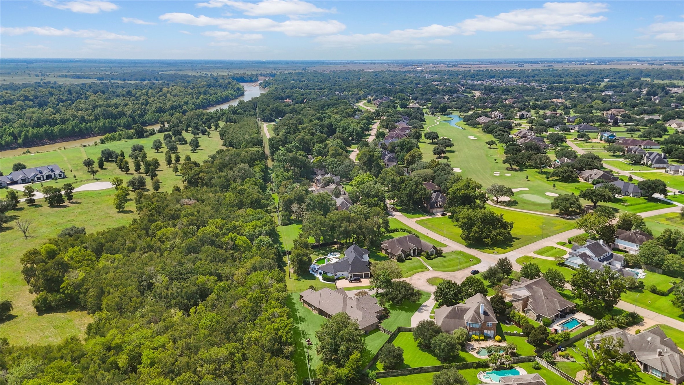 4102 Worthing Drive Fulshear, TX 77441 - Photo 24 of 30 an aerial view of residential houses with outdoor space and trees