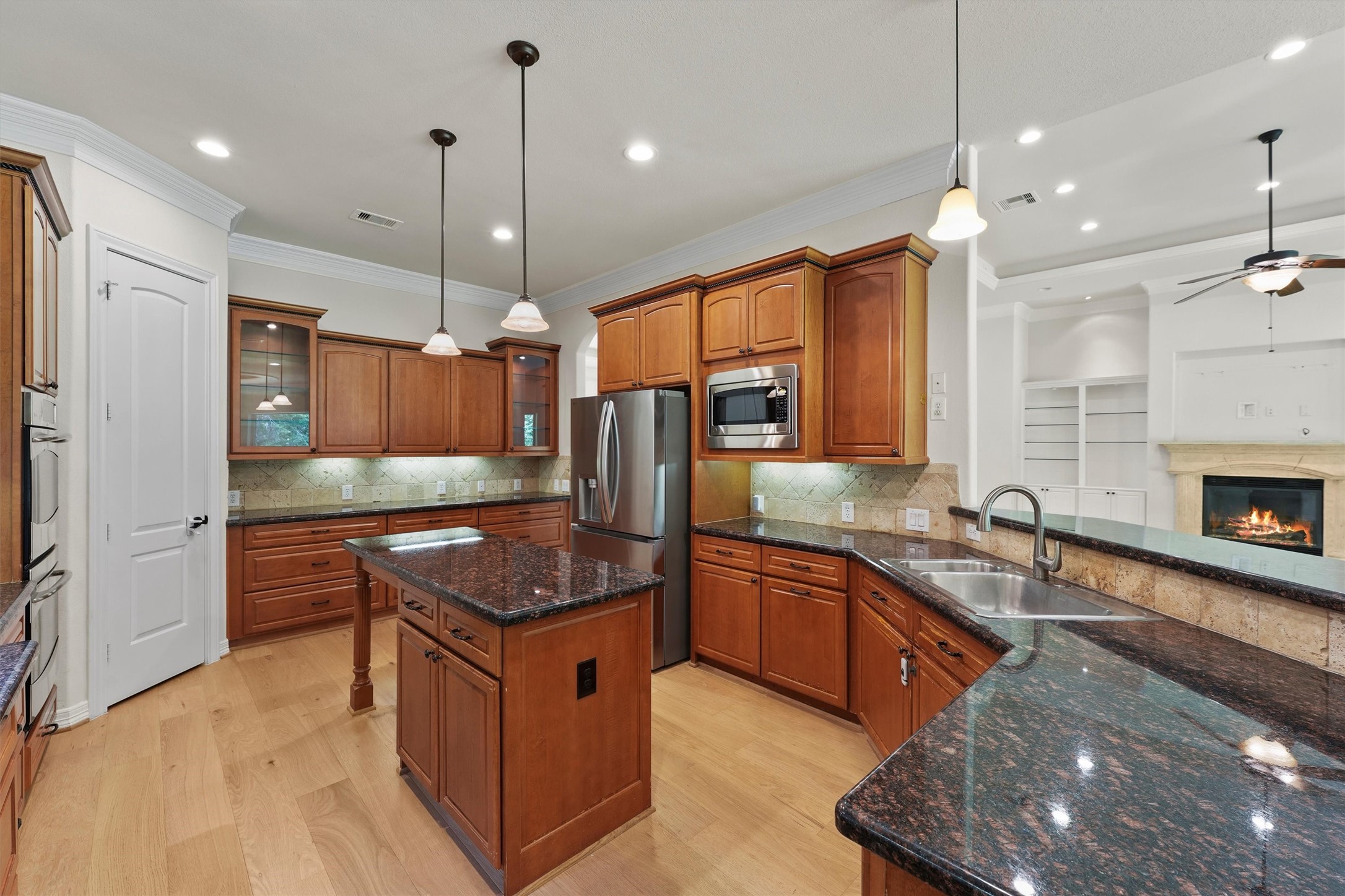 4102 Worthing Drive Fulshear, TX 77441 - Photo 9 of 30 a kitchen with stainless steel appliances granite countertop a sink a stove and a refrigerator