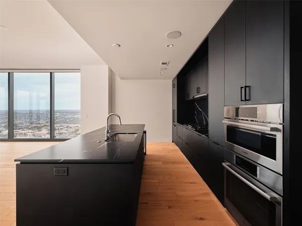 a kitchen with a sink and large stainless steel appliances