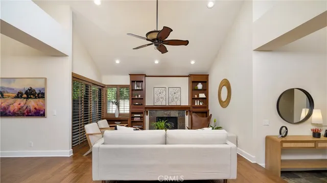 a living room with fireplace furniture and a large window