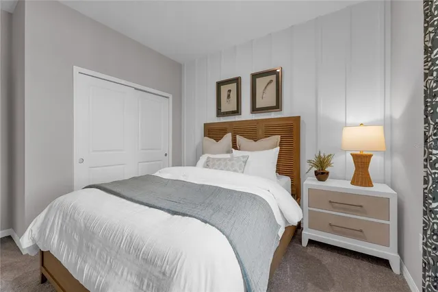 a bedroom with a bed and a night stand