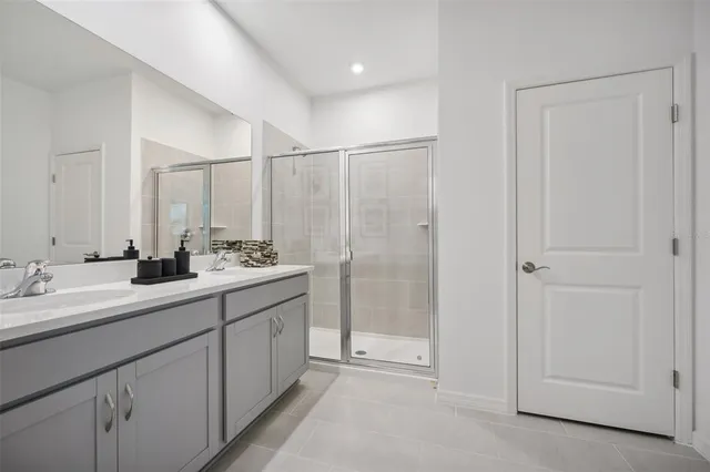a bathroom with a double vanity sink and mirror