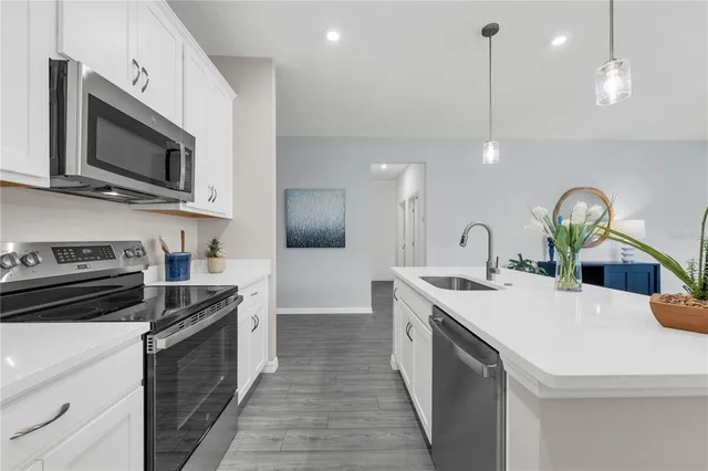 a kitchen with a sink stove and microwave