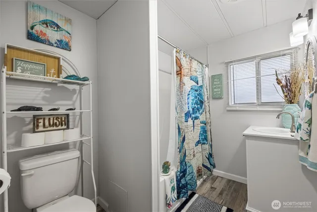 a bathroom with a toilet a sink and a window