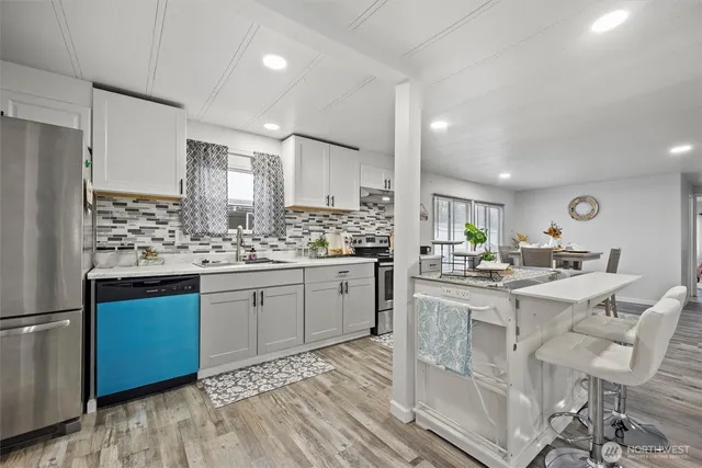 a kitchen with granite countertop appliances cabinets and furniture