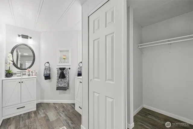 a view of a storage and utility room with wooden floor