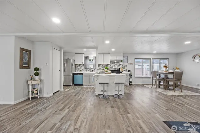 a view of a kitchen with dining table chairs and wooden floor
