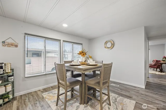 a dining room with furniture and wooden floor