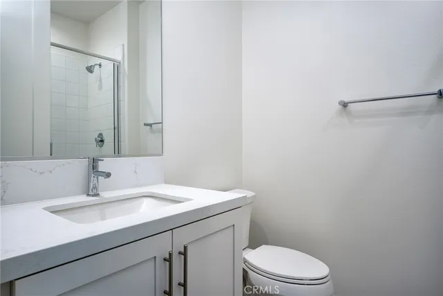 a bathroom with a sink a toilet and vanity