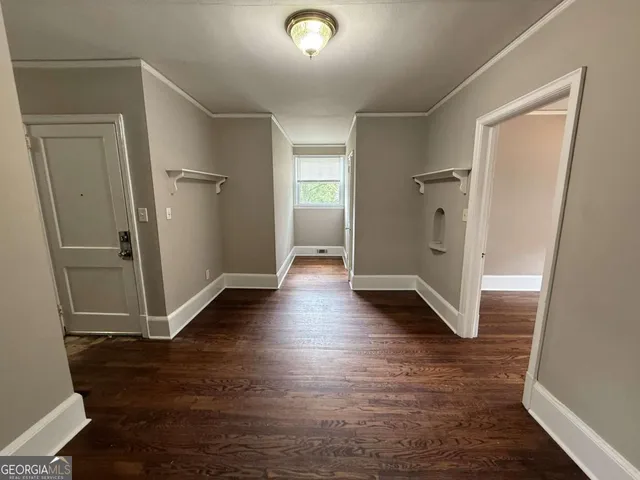 a view of a hallway with wooden floor