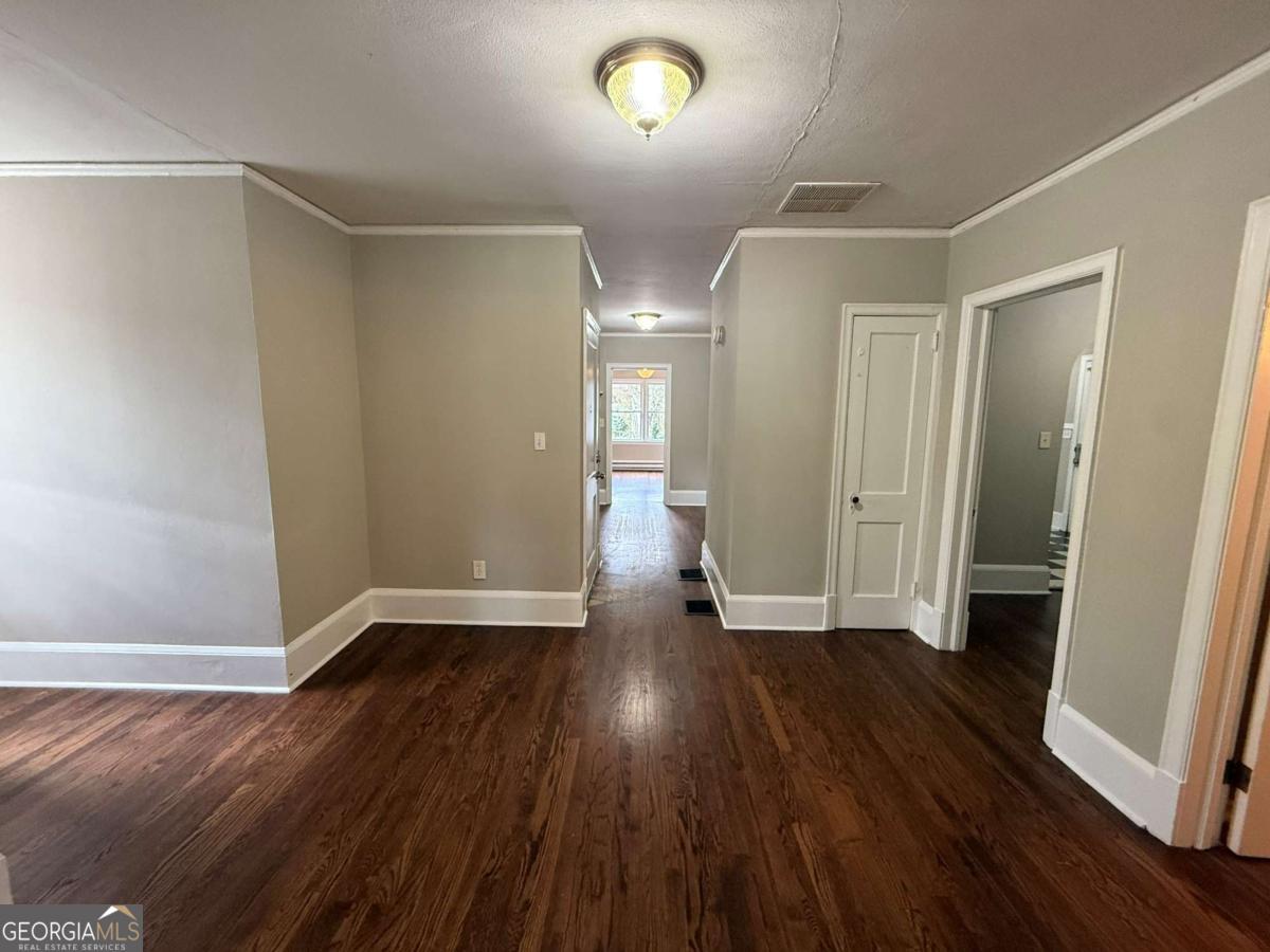 300 Forrest Avenue, Unit B Gainesville, GA 30501 - Photo 4 of 11 an empty room with wooden floor and windows