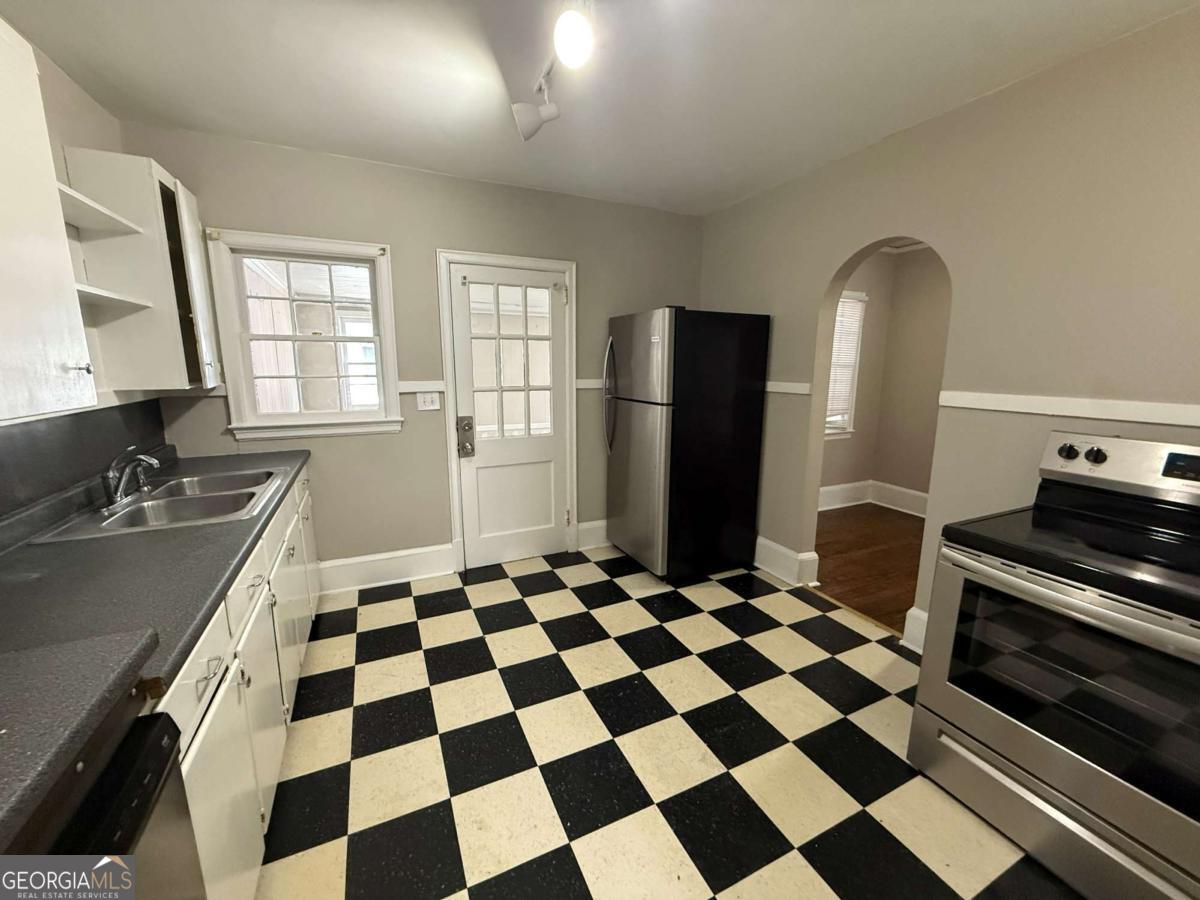 300 Forrest Avenue, Unit B Gainesville, GA 30501 - Photo 5 of 11 a kitchen with a checkered floor and a stove