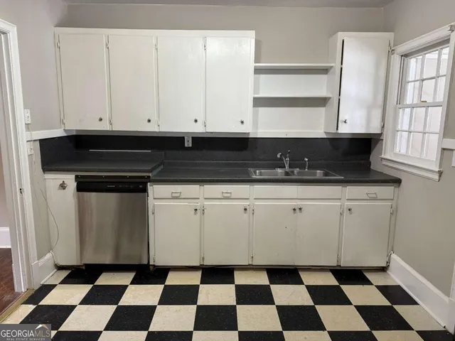 a close view of a granite and white cabinets