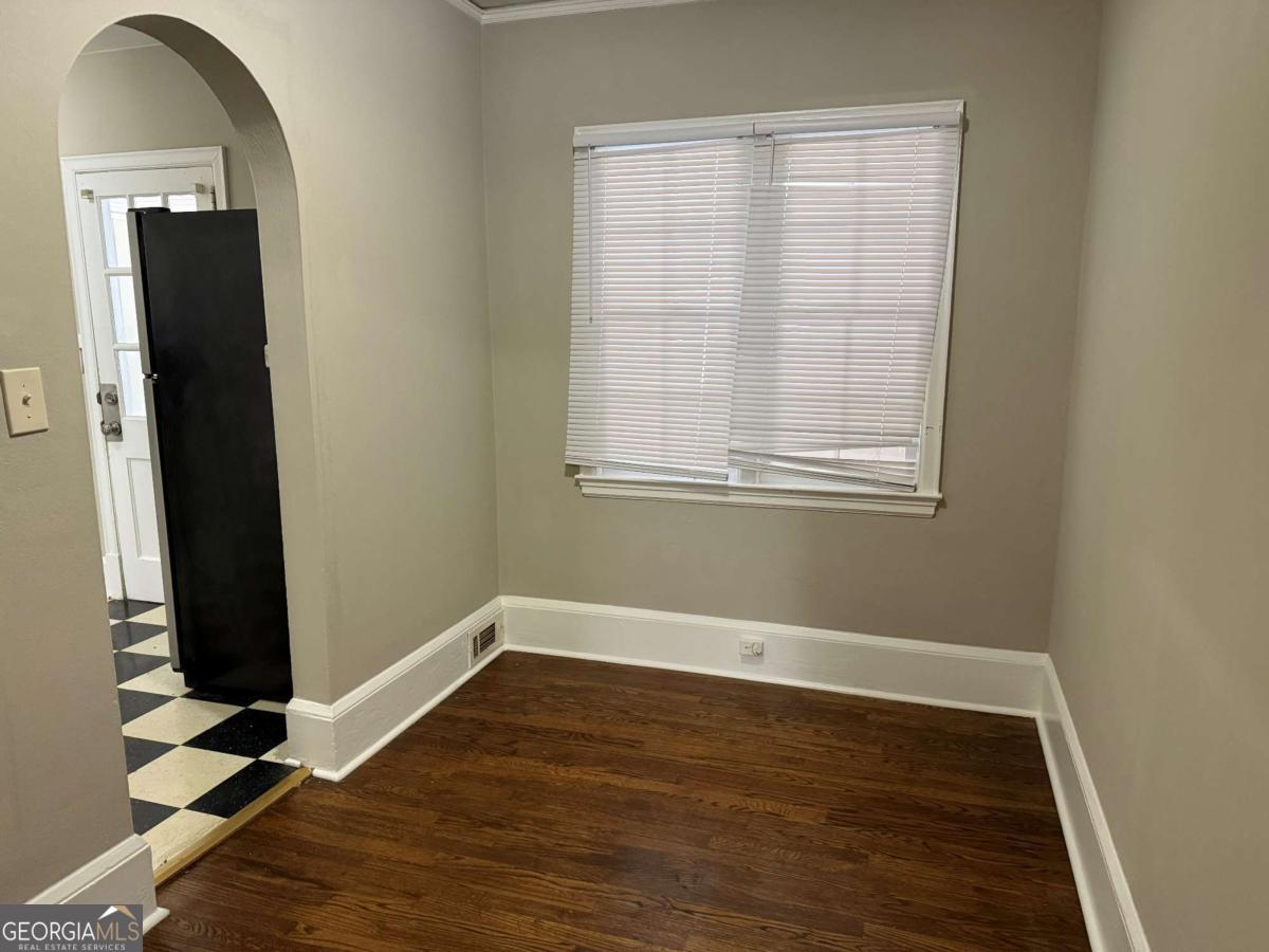 300 Forrest Avenue, Unit B Gainesville, GA 30501 - Photo 7 of 11 an empty room with wooden floor and windows