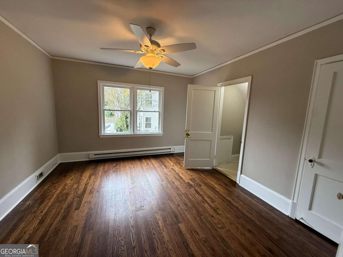 300 Forrest Avenue, Unit B Gainesville, GA 30501 - Photo 8 of 11 wooden floor in an empty room with a window