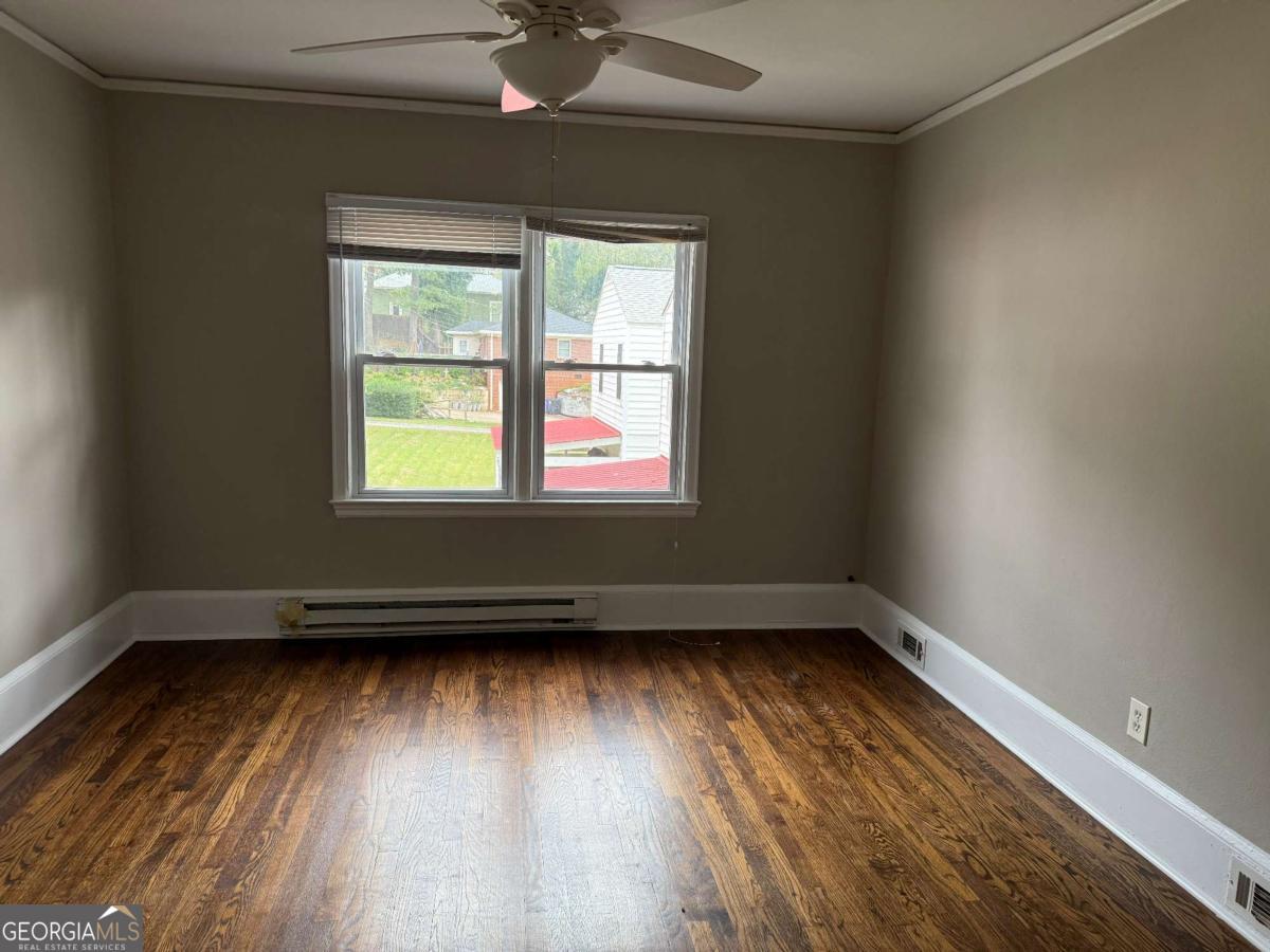 300 Forrest Avenue, Unit B Gainesville, GA 30501 - Photo 10 of 11 an empty room with wooden floor and windows