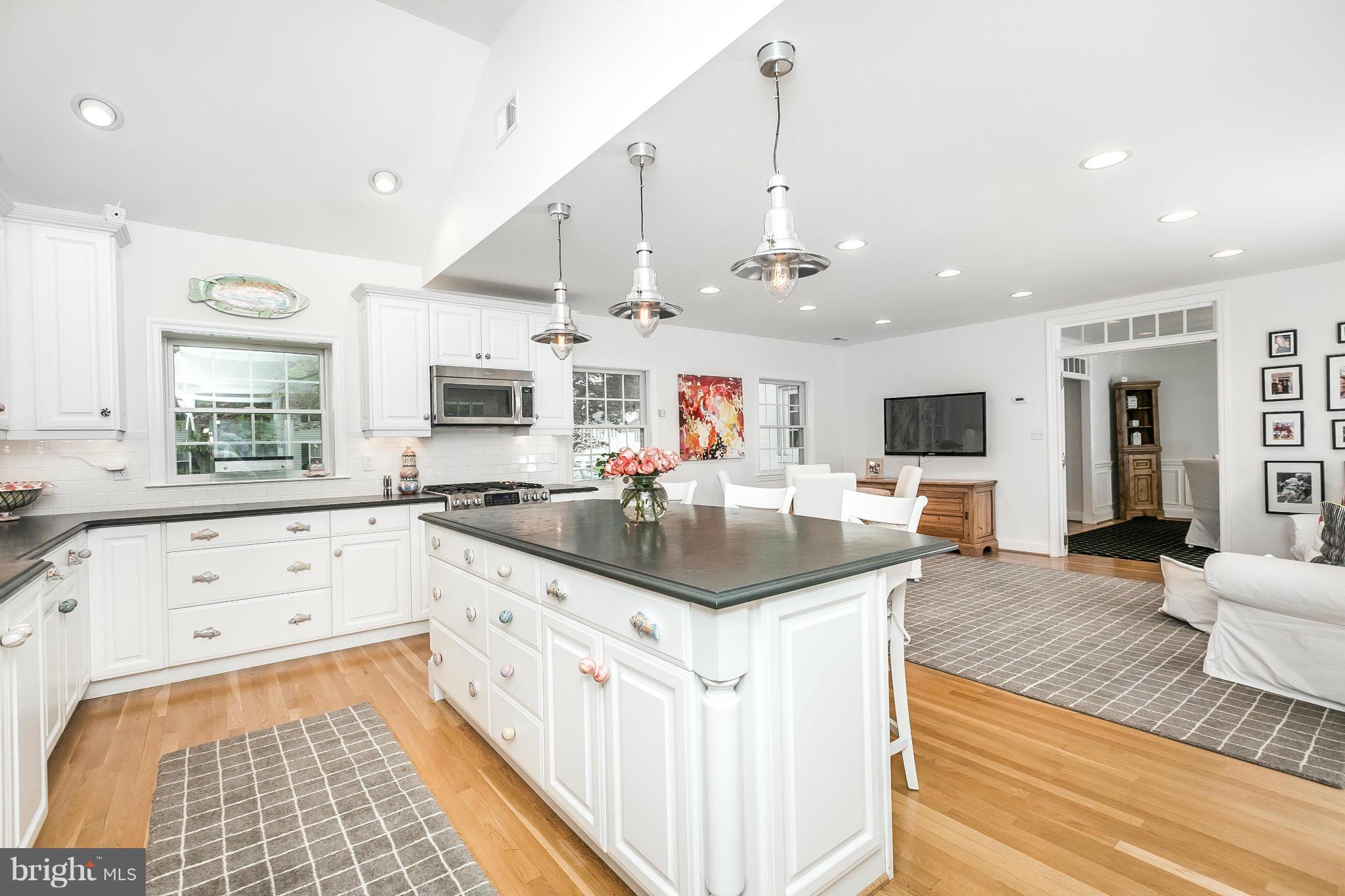 5700 Kenmore Road Baltimore, MD 21210 - Photo 13 of 30 a kitchen with stainless steel appliances kitchen island granite countertop a sink and cabinets
