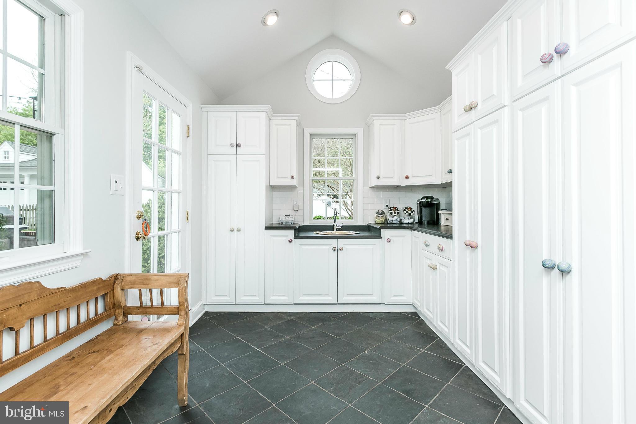 5700 Kenmore Road Baltimore, MD 21210 - Photo 14 of 30 a kitchen with granite countertop white cabinets and white appliances