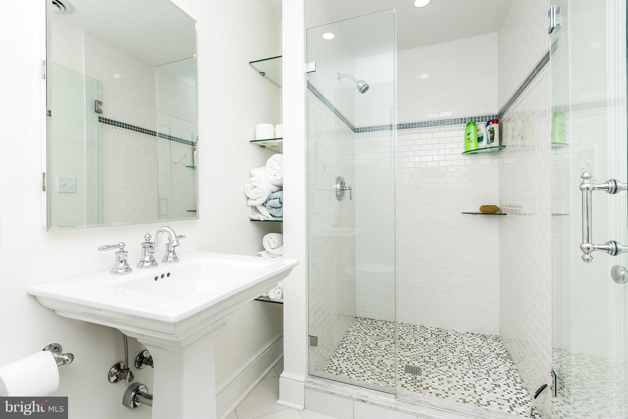 5700 Kenmore Road Baltimore, MD 21210 - Photo 22 of 30 a bathroom with a sink shower and a mirror