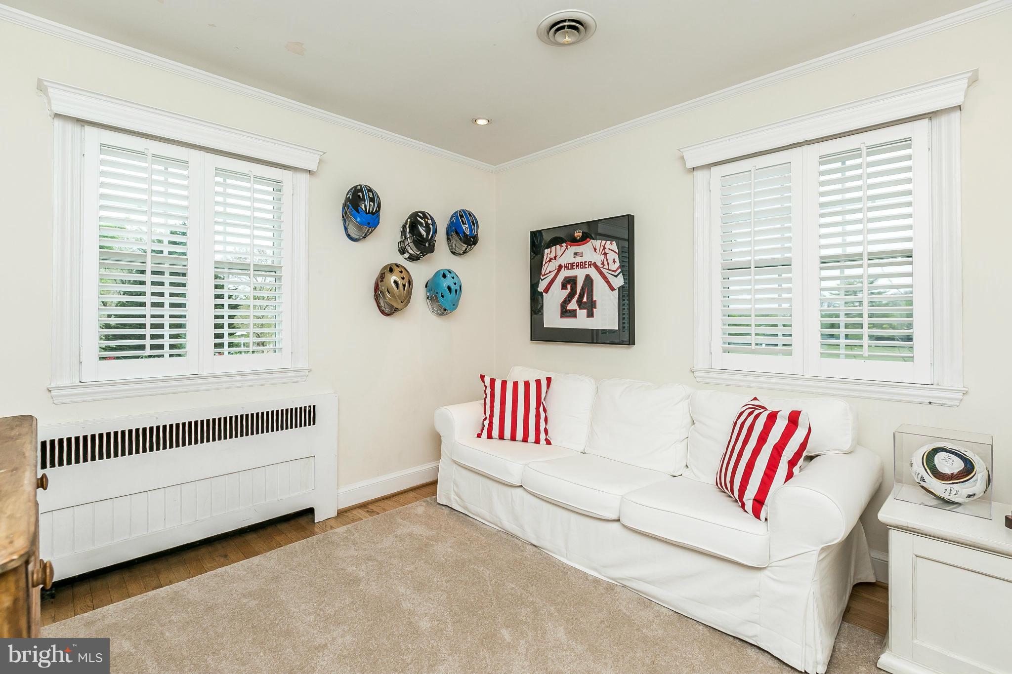 5700 Kenmore Road Baltimore, MD 21210 - Photo 23 of 30 a living room with a white wall next to a window