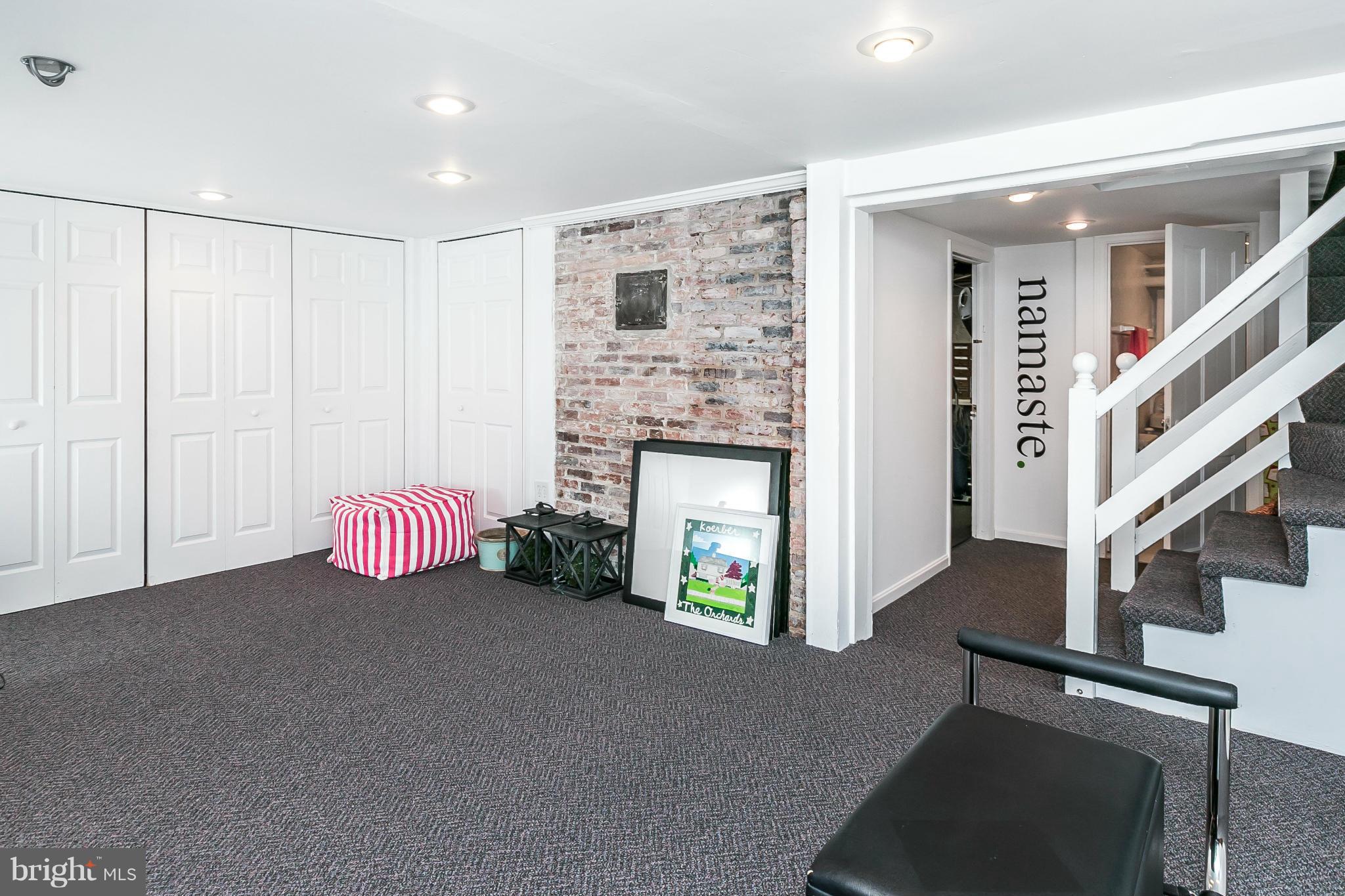 5700 Kenmore Road Baltimore, MD 21210 - Photo 24 of 30 a view of an empty room with wooden floor and a fireplace
