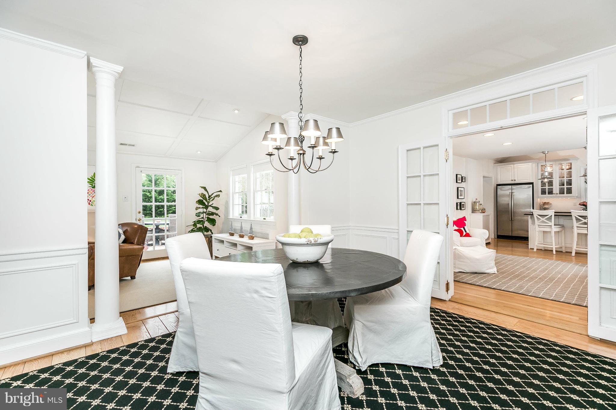 5700 Kenmore Road Baltimore, MD 21210 - Photo 7 of 30 a dining room with furniture a chandelier and wooden floor