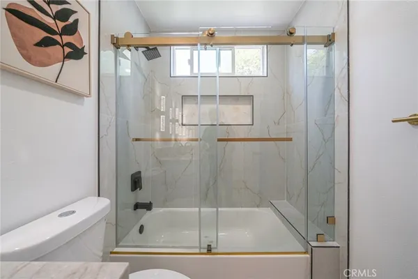a bathroom with a tub and shower