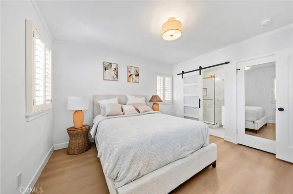 a spacious bedroom with a bed and a window