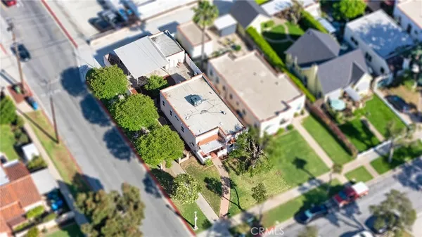 an aerial view of a house with a yard and garden