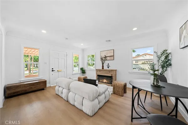a spacious bedroom with a bed a table and a potted plant