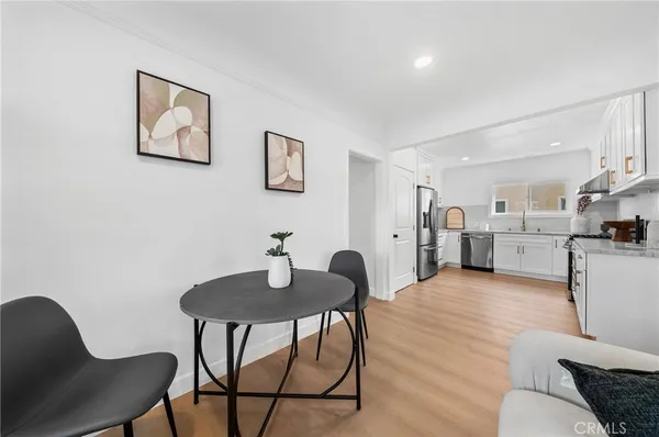 a living room with furniture and kitchen view