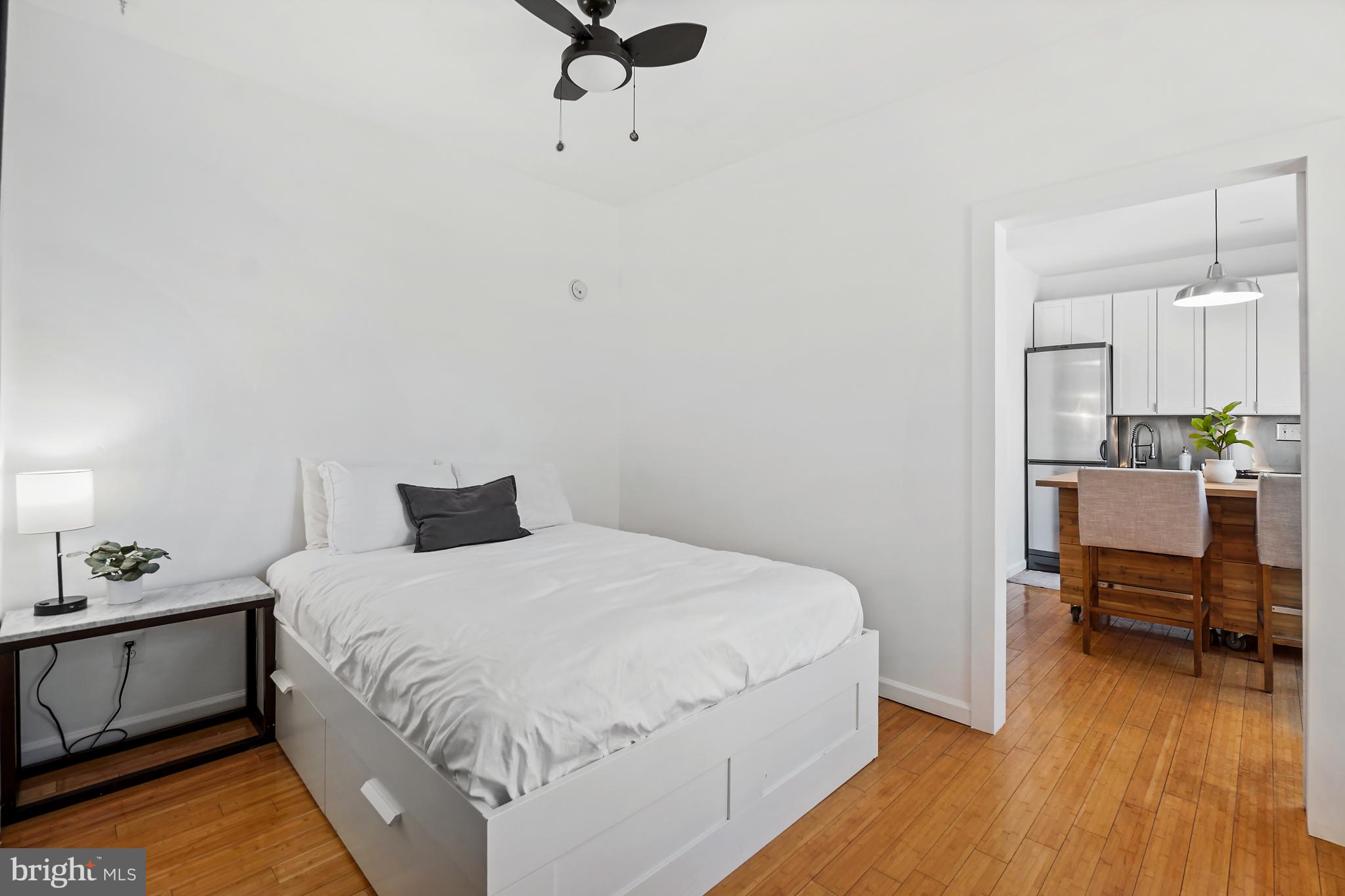 1822 15th Street Northwest, Unit 303 Washington, DC 20009 - Photo 10 of 22 a bedroom with a bed and a table in it