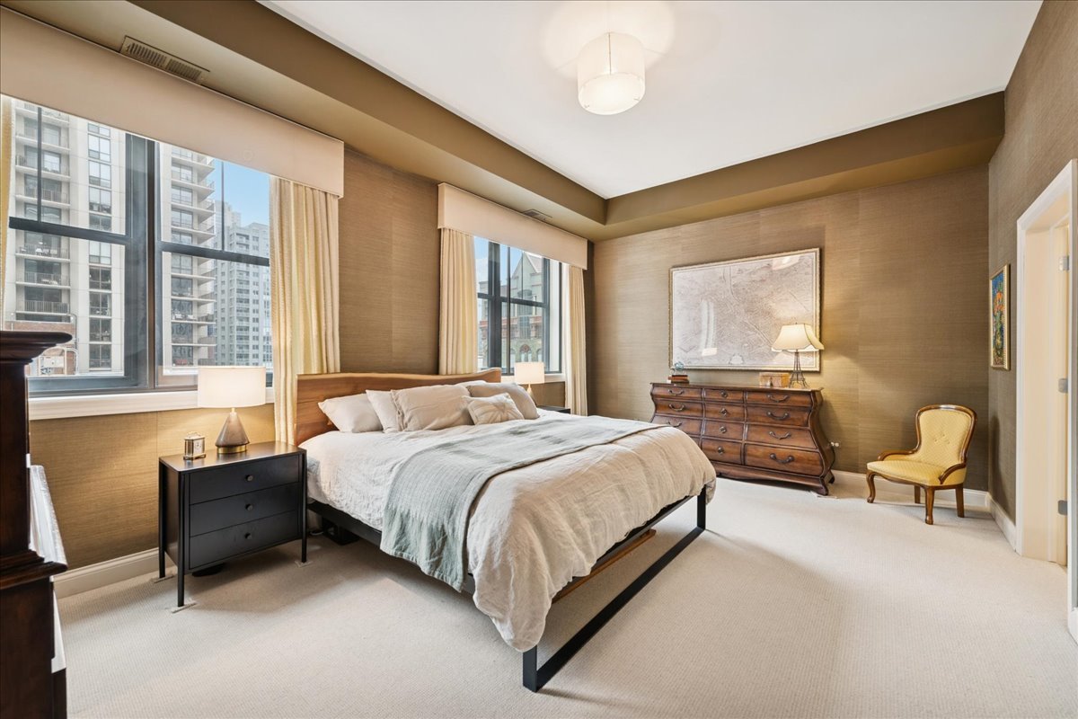 30 West Erie Street, Unit 601 Chicago, IL 60654 - Photo 16 of 30 a bedroom with a bed chair and next to a window