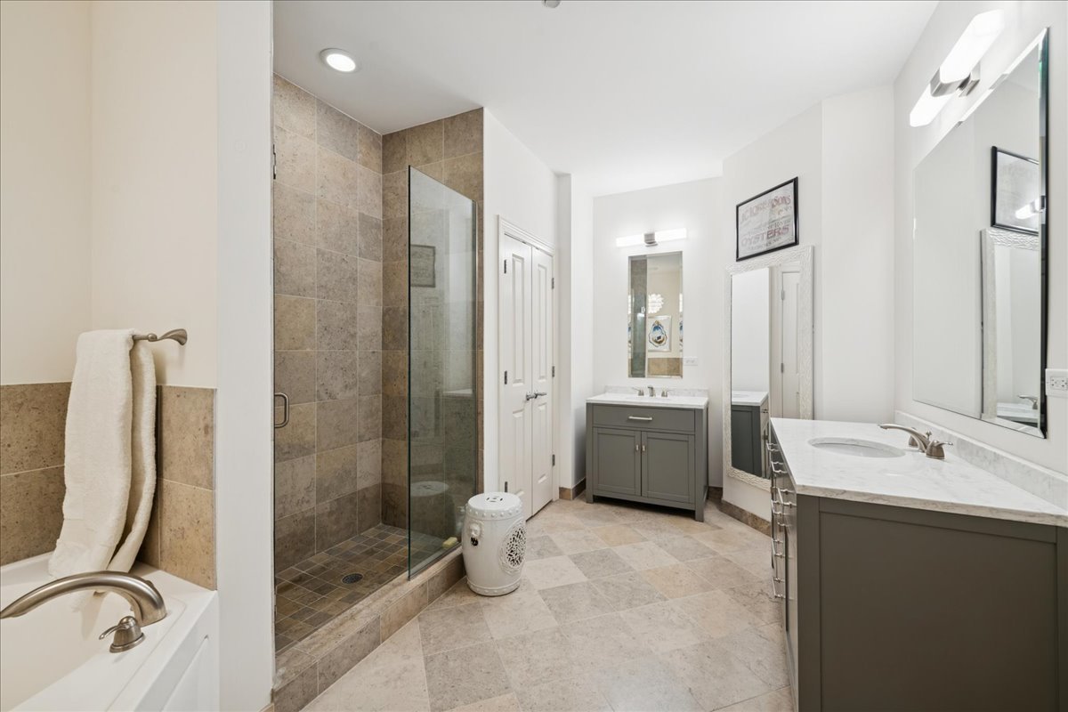 30 West Erie Street, Unit 601 Chicago, IL 60654 - Photo 18 of 30 a bathroom with a tub sink toilet and mirror