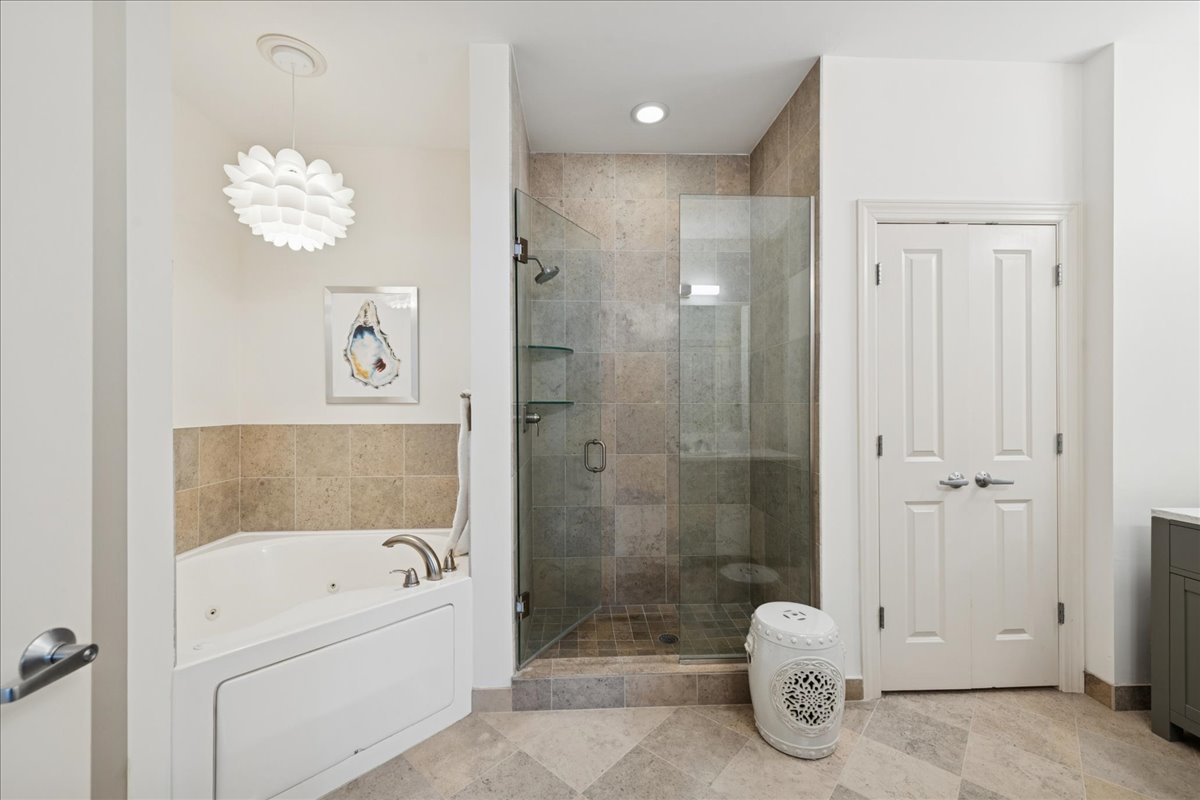 30 West Erie Street, Unit 601 Chicago, IL 60654 - Photo 19 of 30 a bathroom with a shower a bathtub and a shower
