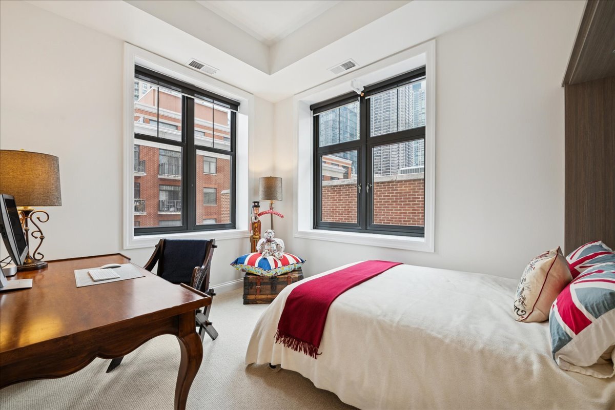30 West Erie Street, Unit 601 Chicago, IL 60654 - Photo 22 of 30 a bedroom with a bed and a window