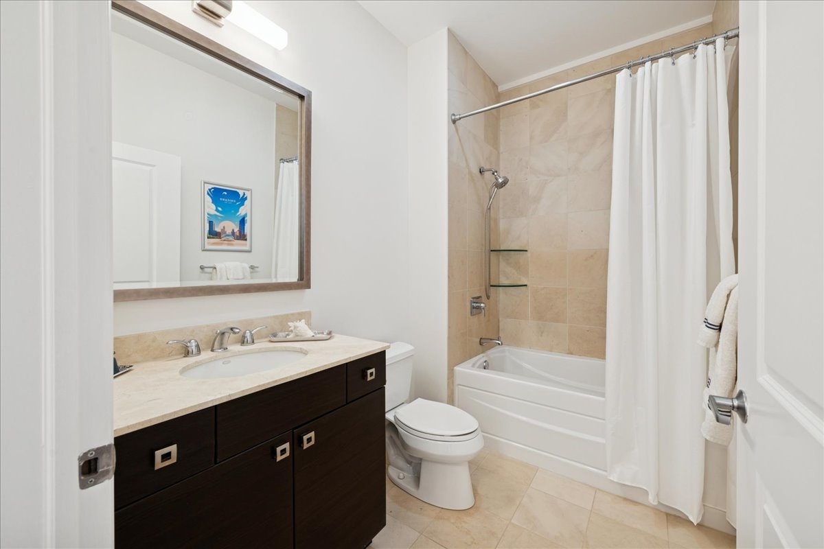 30 West Erie Street, Unit 601 Chicago, IL 60654 - Photo 25 of 30 a bathroom with a shower sink vanity mirror and toilet