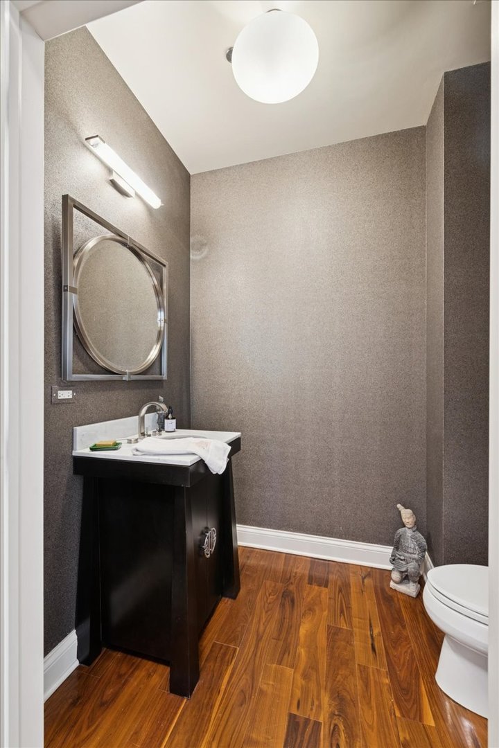 30 West Erie Street, Unit 601 Chicago, IL 60654 - Photo 26 of 30 a bathroom with a sink and a mirror
