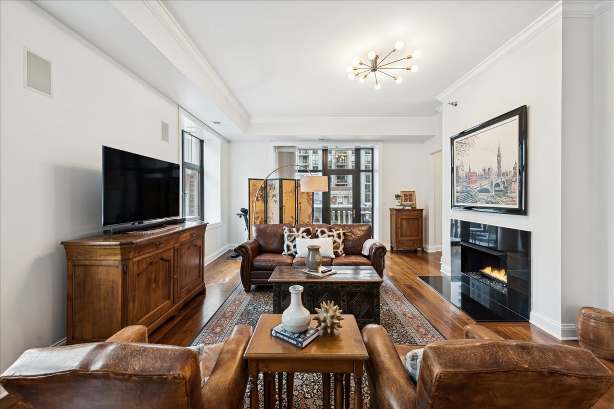 30 West Erie Street, Unit 601 Chicago, IL 60654 - Photo 6 of 30 a living room with furniture and a flat screen tv