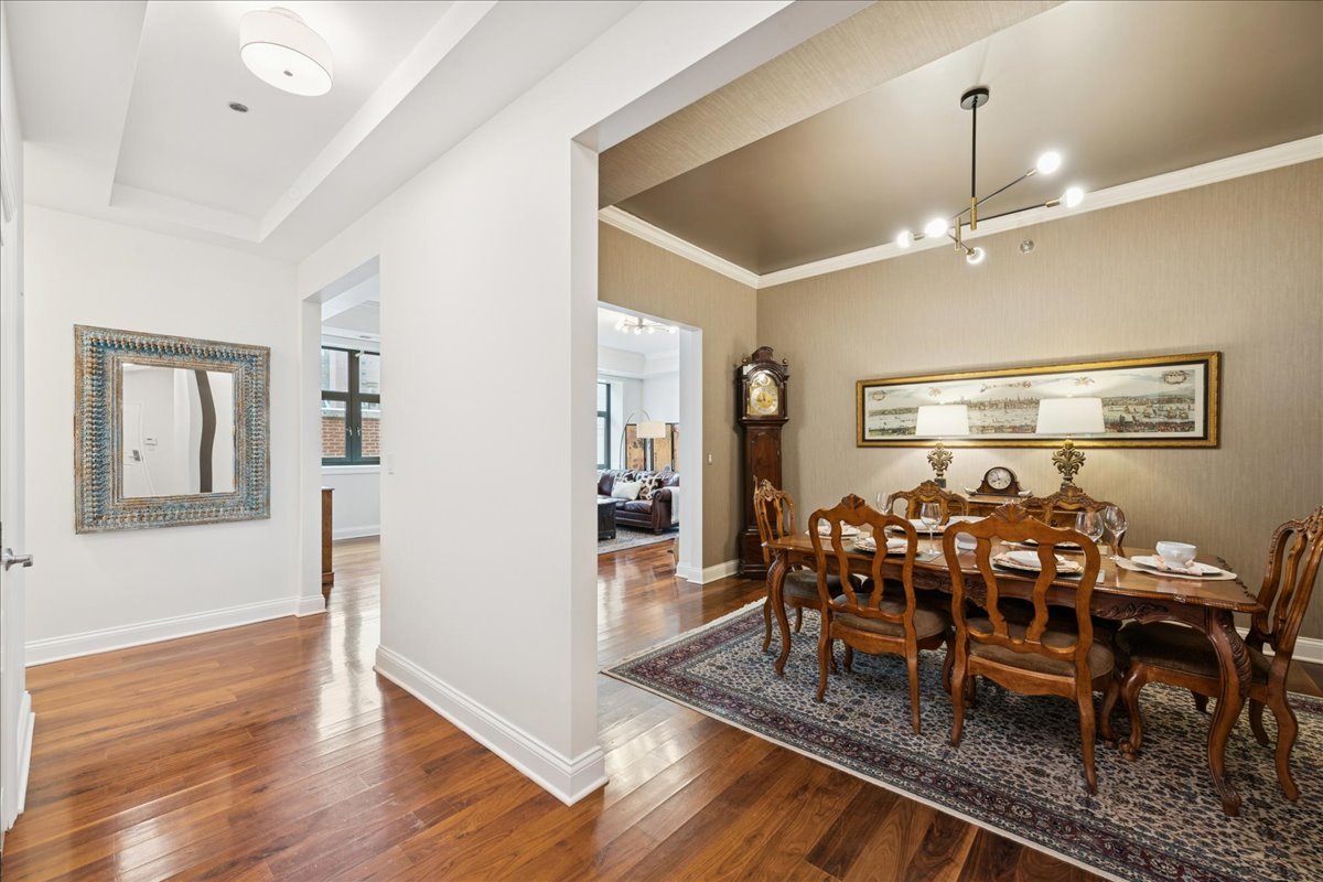 30 West Erie Street, Unit 601 Chicago, IL 60654 - Photo 8 of 30 a view of a dining room with furniture window and wooden floor