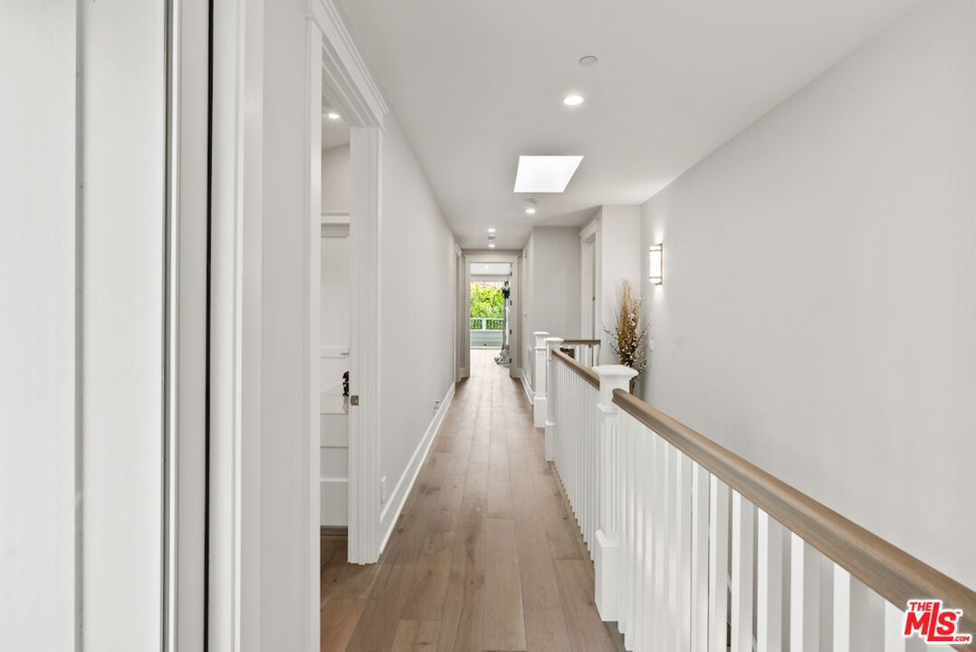 592 30th Street Manhattan Beach, CA 90266 - Photo 24 of 57 a view of a hallway with wooden floor and staircase