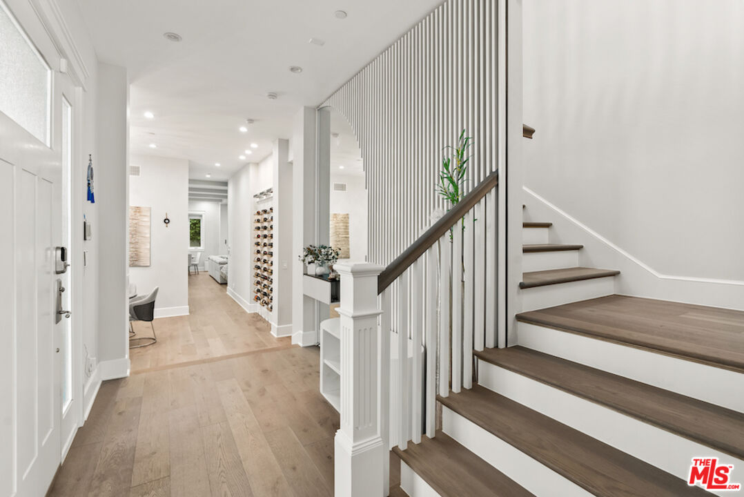 592 30th Street Manhattan Beach, CA 90266 - Photo 25 of 57 a view of a hallway with wooden floor and staircase