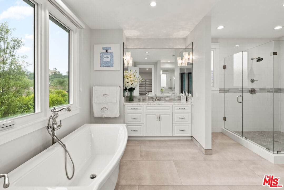 592 30th Street Manhattan Beach, CA 90266 - Photo 28 of 57 a bathroom with a granite countertop sink a large mirror and a bathtub