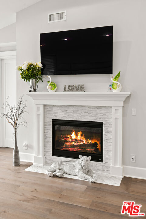 592 30th Street Manhattan Beach, CA 90266 - Photo 31 of 57 a living room with a fireplace and a potted plant