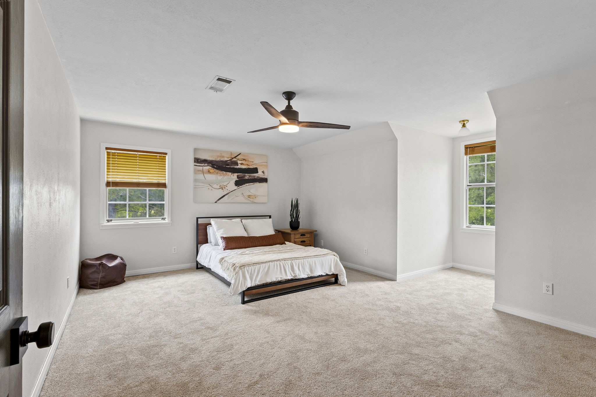 16421 Westbury Road Beaumont, TX 77713 - Photo 22 of 29 a bedroom with a bed and a chandelier